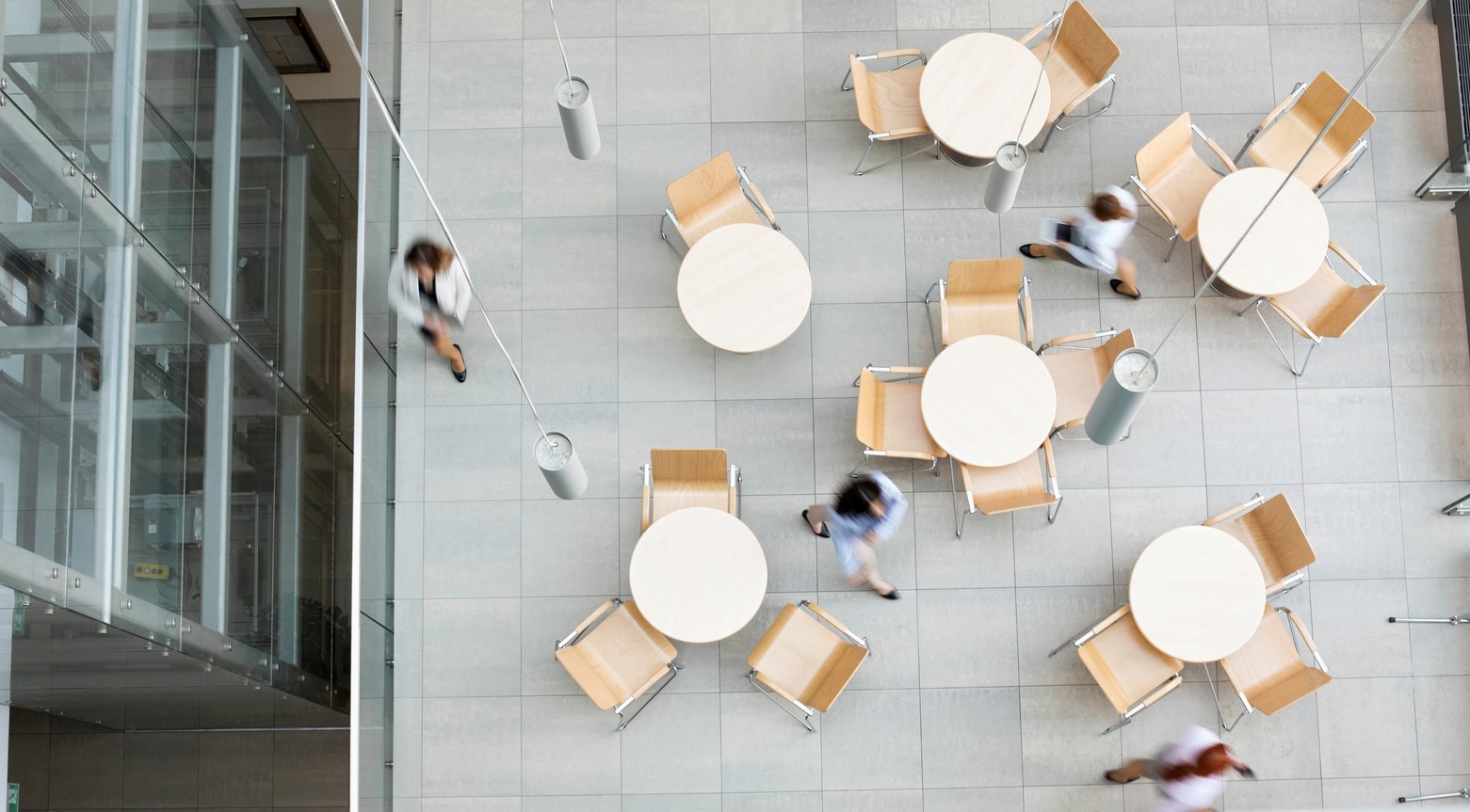 Blurred motion of businesswomen walking at office canteen